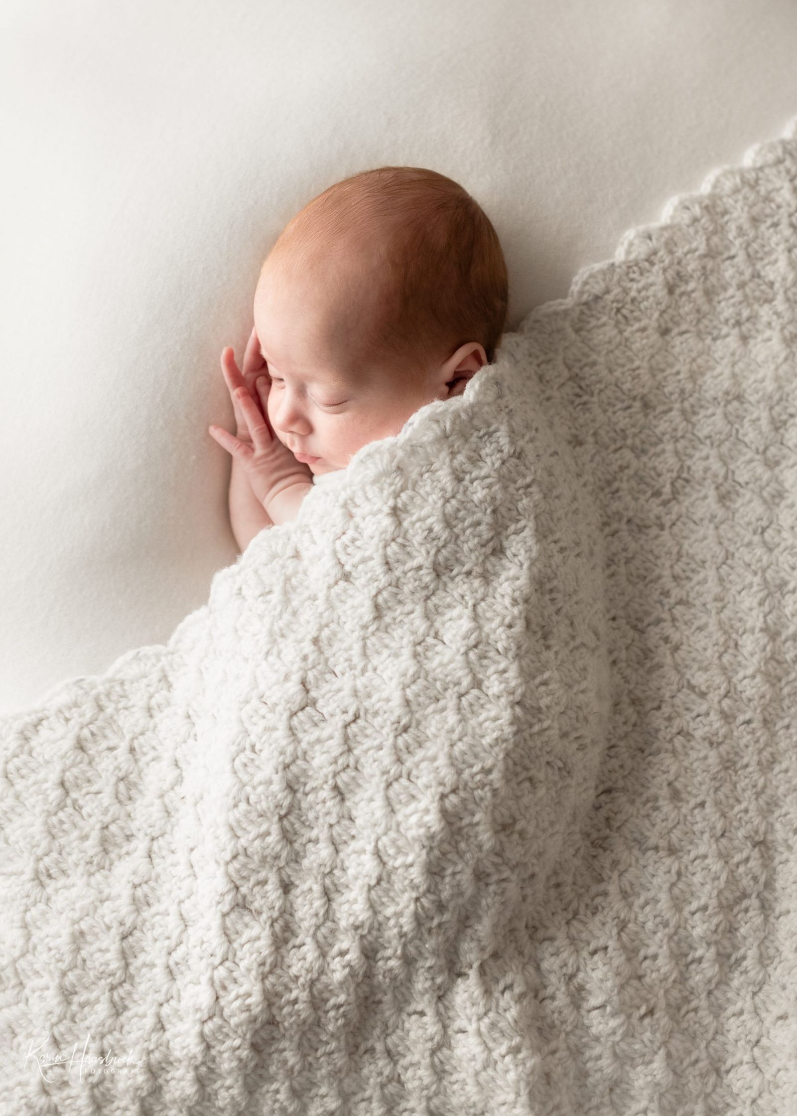 newborn baby with handmade blanket